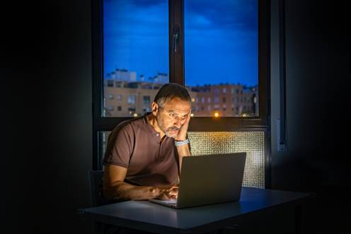Man stressed looking at laptop - Sexual Discrimination
